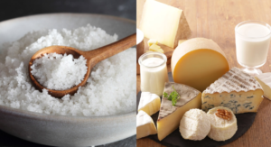 7 Worst Foods For Kidneys You Should Avoid 3 A bowl of coarse salt with a wooden spoon beside an assortment of cheeses, milk, and cream on a wooden board.