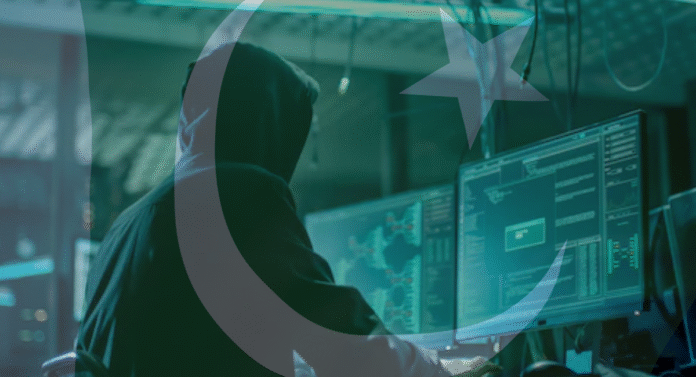 A hooded figure sits at computer screens displaying code and data, overlaid with the crescent moon and star symbol of Pakistan.