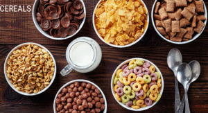 Foods Not to Refrigerate: 15 items That your Storing Wrong 13 An array of cereals in white bowls, including chocolate, cornflakes, granola, and colorful rings, with a small jug of milk and spoons.