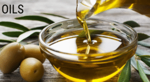 Foods Not to Refrigerate: 15 items That your Storing Wrong 15 A glass bowl filled with golden oil, with olives and olive leaves nearby, displayed on a rustic wooden surface.