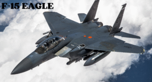Top Fighter Jets 2025: The World's Most Advanced Aircraft 4 An F-15 Eagle jet flies above fluffy white clouds, showcasing its sleek design and military markings. Text overlay reads "F-15 EAGLE."