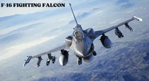 Top Fighter Jets 2025: The World's Most Advanced Aircraft 1 An F-16 Fighting Falcon jet flies over mountainous terrain, equipped with missiles and bombs, showcasing its advanced military capabilities.