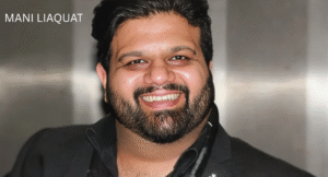 Love Guru Cast Spotlight: Mahira Khan, Humayun Saeed and More 10 Mani Liaquat, in a black suit, stands in front of a neutral background, exuding confidence and style.