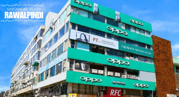 Oppo storefront in Singapore Plaza, Rawalpindi, showcasing vibrant signage with multiple floors and prominent advertisements.