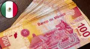 A stack of Mexican 100 peso bills with "Banco de México" printed prominently, alongside a circular Mexican flag emblem.
