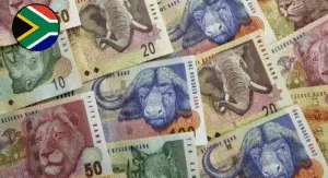 A close-up of a hand holding a 75 Pakistani Rupee note, featuring green and blue hues with text and design elements.