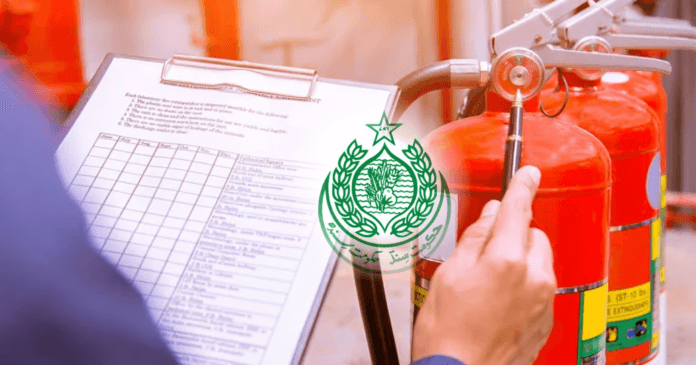 A close-up of a hand holding a pen, inspecting fire extinguishers with a checklist and Sindh logo in the background.